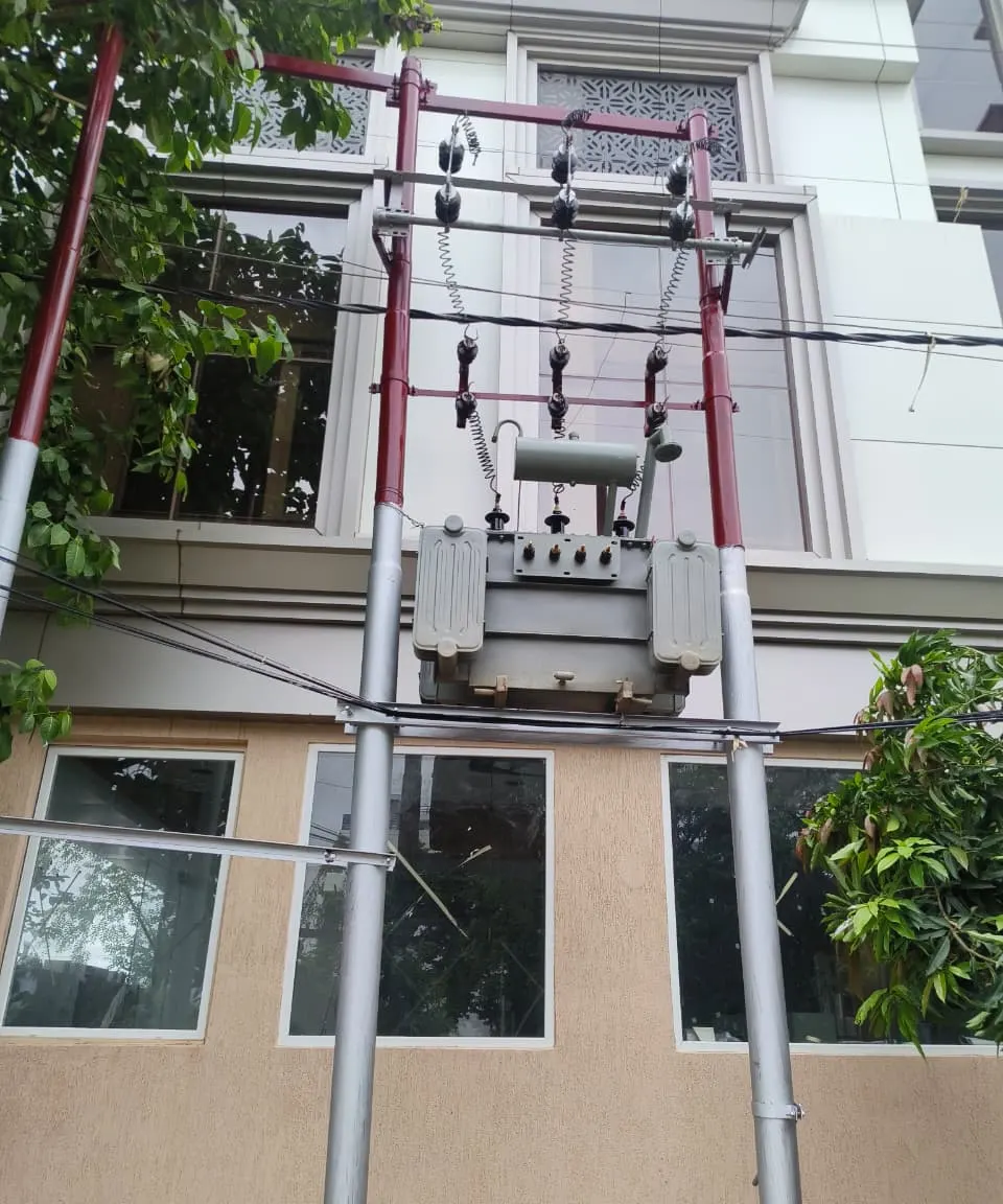 Double-pole structure carrying overhead line hardware and a transformer